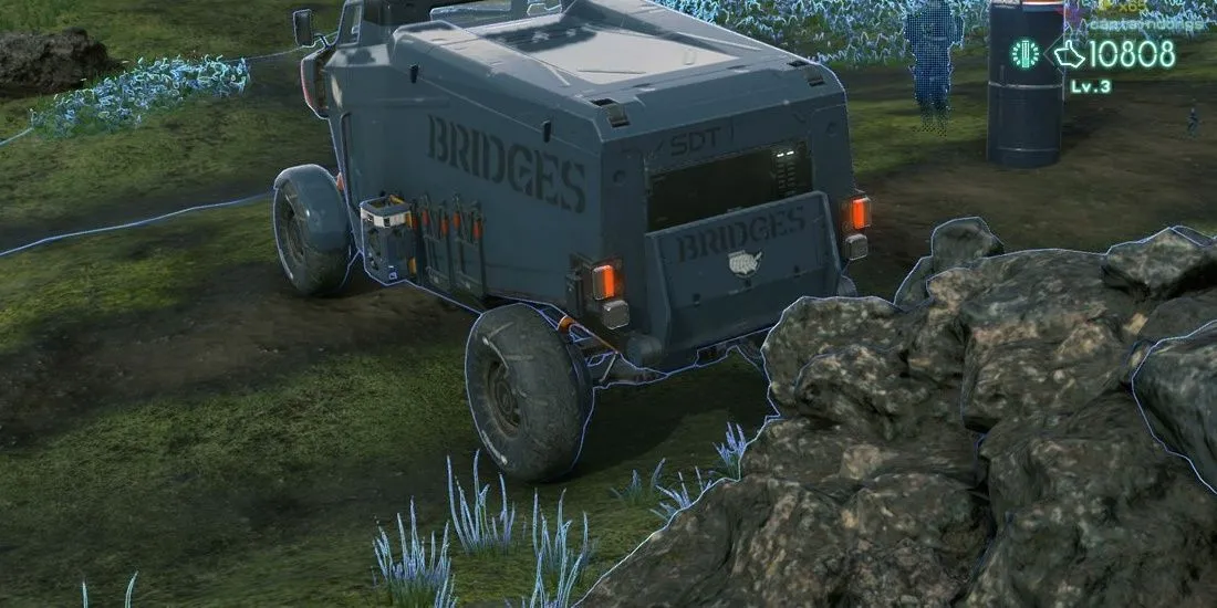 Một chiếc xe tải đậu cạnh tảng đá lớn trong thế giới Death Stranding.