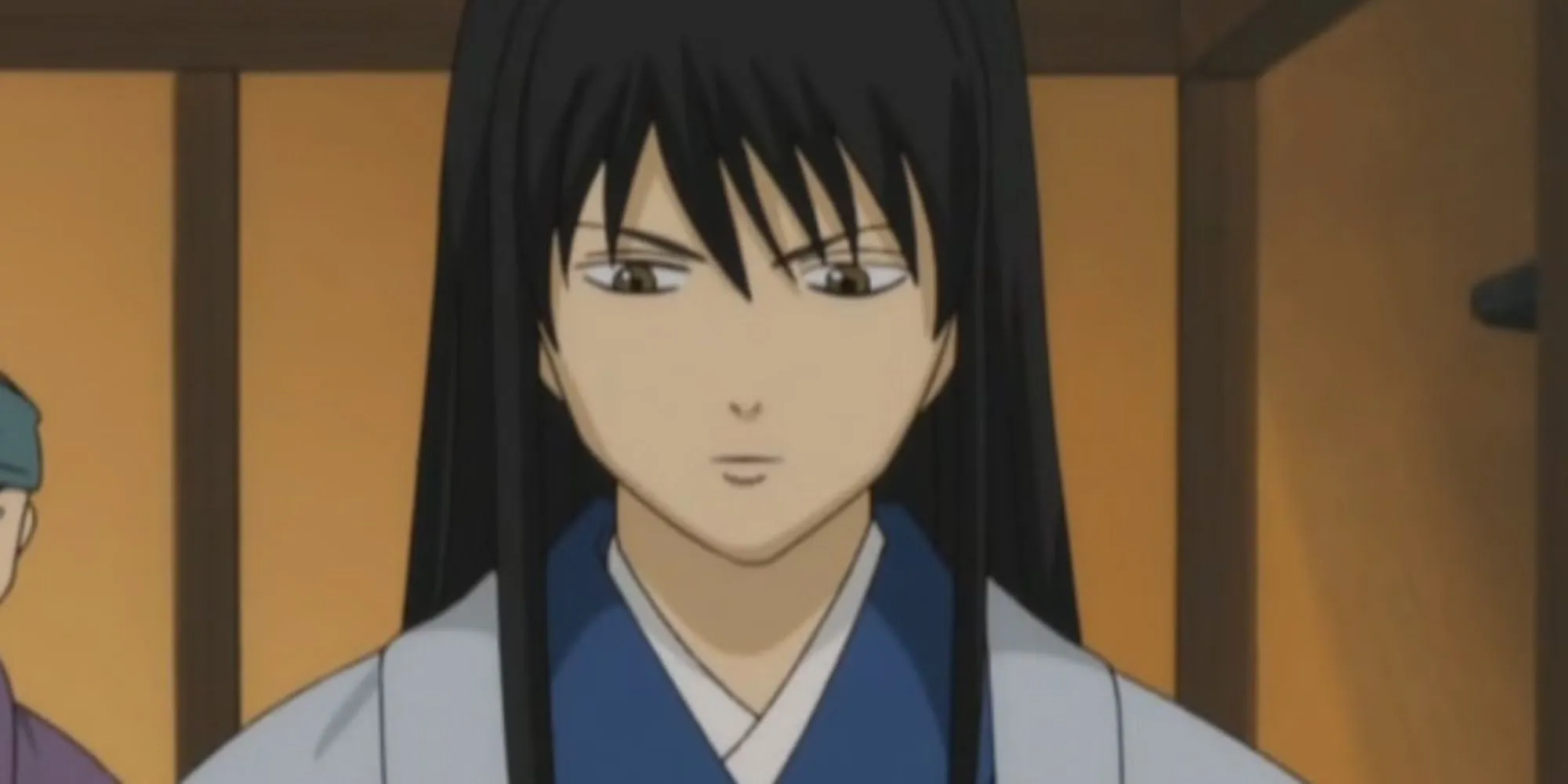 Kotarou Katsura trong một bộ ngụy trang lố bịch, phản ánh sự điên rồ và hài hước bên ngoài, nhưng sâu thẳm là nỗi đau của một nhà cách mạng đã mất mát quá nhiều.